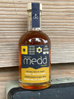 Bottle of Mountain Mead with mountains in background