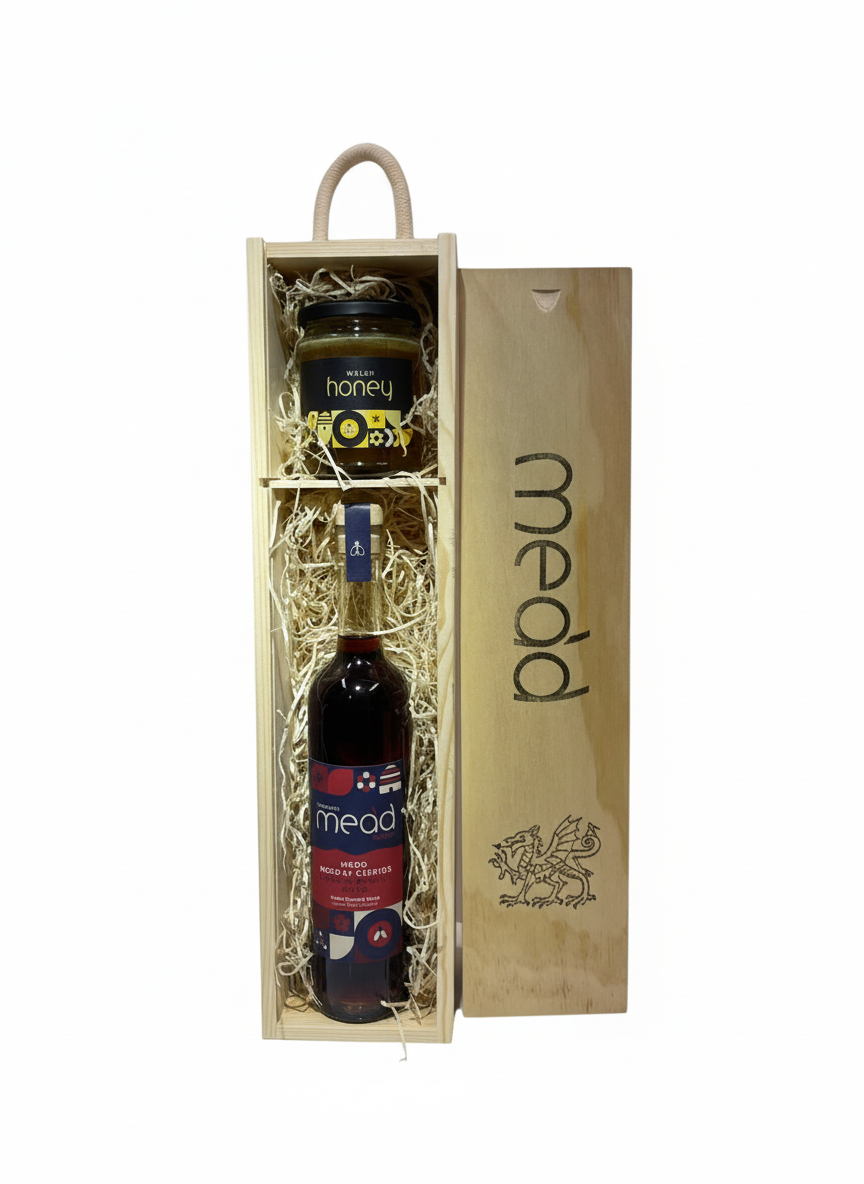 Cherry mead with jar of honey in wooden gift box